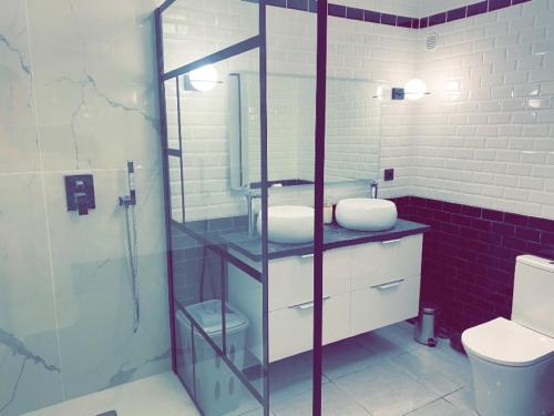 a bathroom with a sink and a glass shower at Super apt Parking + Clim 5 min du centre & gare in Sète