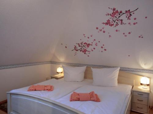 ein Schlafzimmer mit einem Bett mit Blumen an der Wand in der Unterkunft Ferienwohnung N24 in Graal-Müritz