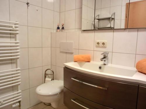 a bathroom with a sink and a toilet at Ferienwohnung L36 in Graal-Müritz