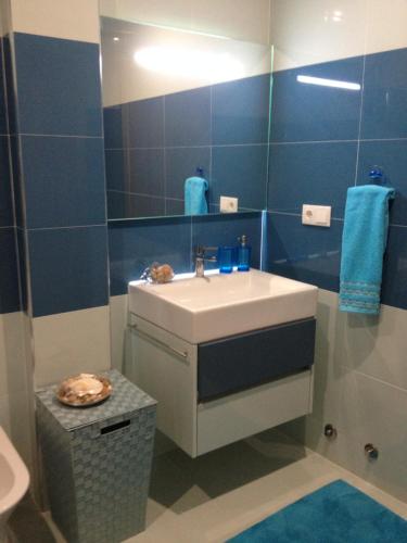 a bathroom with a sink and a mirror at Blue House in Vila Franca do Campo