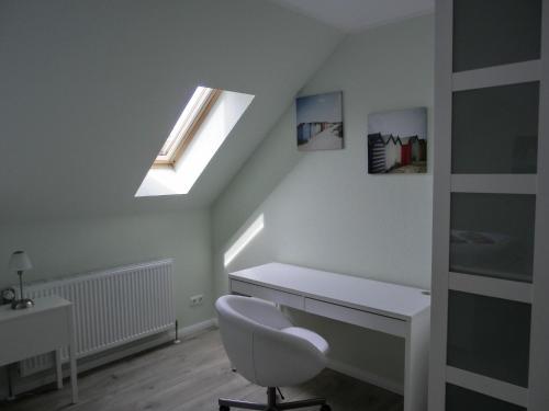 a bathroom with a white desk and a window at Ferienwohnung P15 in Graal-Müritz