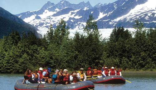 a group of people in a raft on a river at Thunder Mountain Place - Quiet, Comfortable Place Offering DISCOUNT ON TOURS! in Juneau