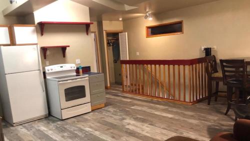 a kitchen with a white refrigerator and a stove at Sluice Box - Affordable, Convenient, and near Mendenhall Glacier- DISCOUNTS ON TOURS! in Mendenhaven