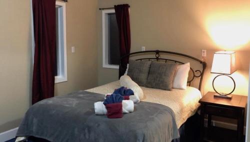 a bedroom with a bed with two stuffed animals on it at Sluice Box - Affordable, Convenient, and near Mendenhall Glacier- DISCOUNTS ON TOURS! in Mendenhaven