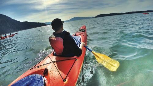 a man is in a kayak in the water at Shangri-La - Near Mendenhall Glacier and Auke Bay -DISCOUNTS ON TOURS! in Mendenhaven