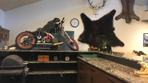 a kitchen counter with a motorcycle on a wall at Shangri-La - Near Mendenhall Glacier and Auke Bay -DISCOUNTS ON TOURS! in Mendenhaven