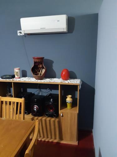 a room with a table and a heater on a wall at Confort y tranquilidad al 100% in Malargüe