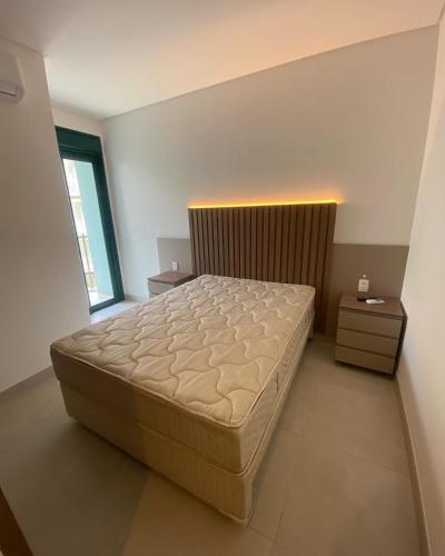 a bedroom with a large bed in a room at DNA UBATUBA in Ubatuba