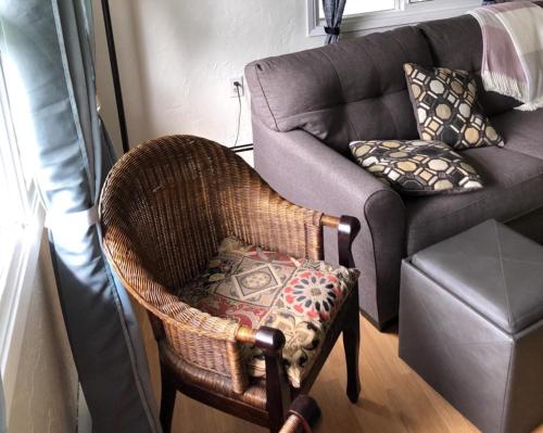 a chair and a couch in a living room at Raw Gold - Affordable, Near Mendenhall Glacier, Trails, and Conveniences - DISCOUNTS ON TOURS! in Mendenhaven