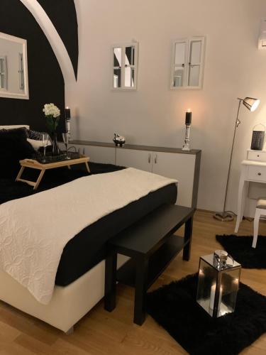 a bedroom with a large bed and a table at Apartment Capital in Maribor