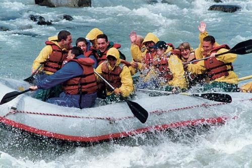 a group of people in a raft in the water at Glacier Guest Room - PRIVATE ROOM IN SHARED HOUSE REDUCED PRICE ON TOURS in Juneau