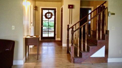 a hallway with a staircase and a door with a window at Glacier Guest Room - PRIVATE ROOM IN SHARED HOUSE REDUCED PRICE ON TOURS in Juneau
