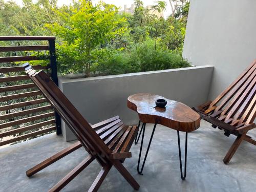a wooden bench sitting in front of a patio at Little Gem Hotel Tulum La Veleta in Tulum