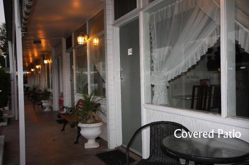 a window of a covered patio with a table and chairs at Hi Way Motor Inn in Yass