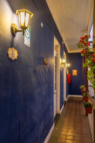 a hallway with a blue wall with a light on it at Casona Jerusalen in Arequipa