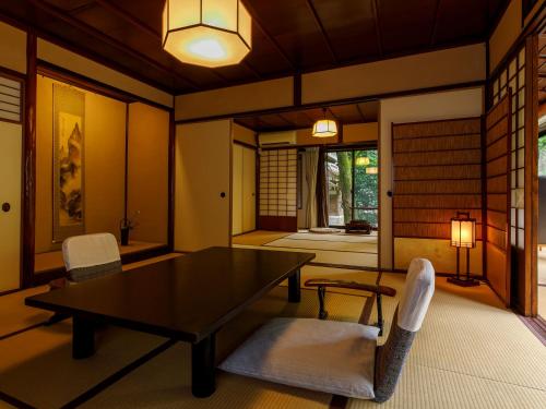 a dining room with a table and two chairs at Motoyu Ishiya in Kanazawa
