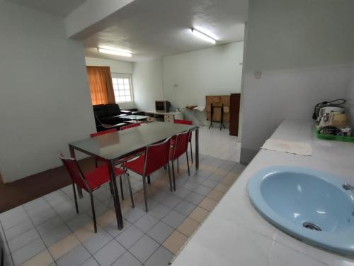 a room with a table and chairs and a sink at Desa Anthurium in Cameron Highlands