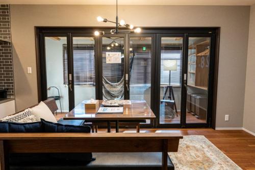 a living room with a couch and a table at HAKATA TERRACE -灯 akari- in Fukuoka