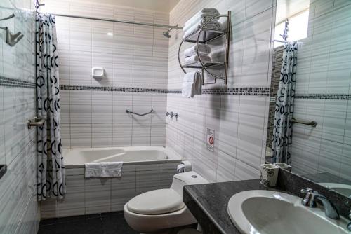 a bathroom with a tub and a toilet and a sink at Hotel Tierra Inka Sacred Valley in Ollantaytambo