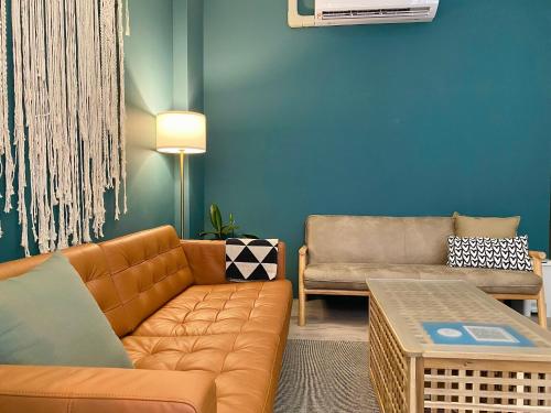 a living room with a couch and a table at 安平言寓包棟旅宿 Ian Apt in Tainan