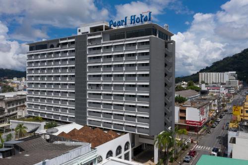 a hotel building with a sign on top of it at Pearl Hotel Phuket in Phuket