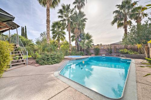 a swimming pool in a yard with palm trees at Vegas Oasis Home with Pool and Spa 7 Miles to Strip in Las Vegas