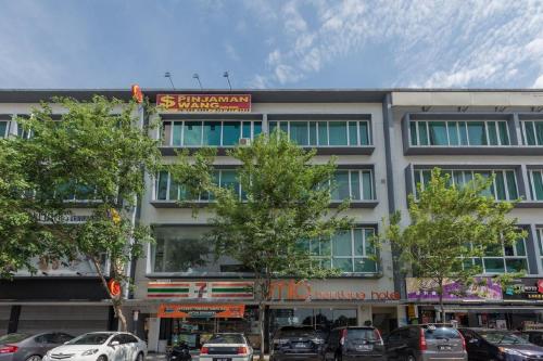 a large building with cars parked in front of it at MIO BOUTIQUE Hotel in Melaka