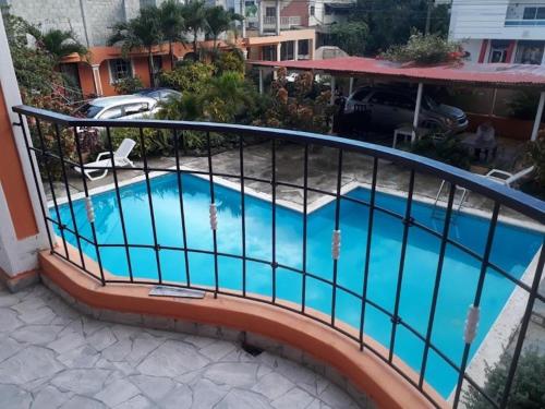 a balcony with a swimming pool with a railing at Apartahotel Next Nivel - Queen room with Ac in Punta Cana