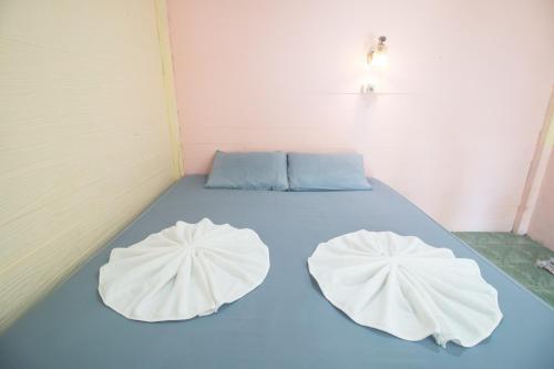a bed in a room with two pillows on it at Best House Resort in Ban Pak Ba Ra