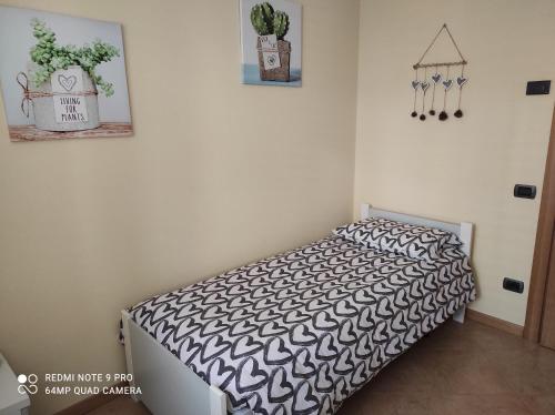 a bedroom with a bed with a black and white comforter at Casa "La Forcella" in Brembilla