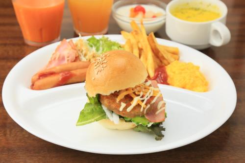 a plate of food with a sandwich and french fries at Ishigakijima Hotel Cucule in Ishigaki Island