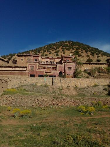 a large house on top of a hill at Gte Tawada - Haut-atlas - Room for 2 people in Ikhf nʼIghir