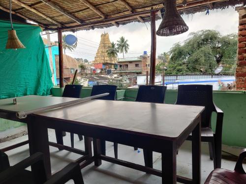 a ping pong table in a room with chairs at All Is Well in Hampi