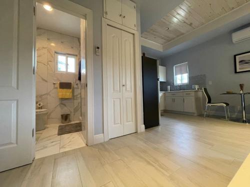 a large room with a white door and a bathroom at Nicoles Nest Brand New Exquisite Studio Hideaway in Freeport