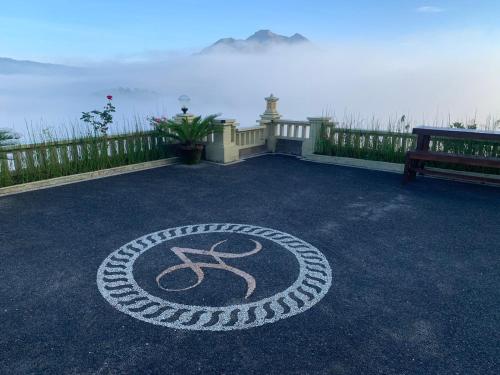 a peace sign on the ground in front of the ocean at Ayodya Batur Villa in Kintamani