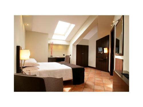 Una cama o camas en una habitación de TH Roma - Carpegna Palace