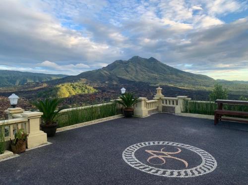 a patio with a bench and a view of a mountain at Ayodya Batur Villa in Kintamani
