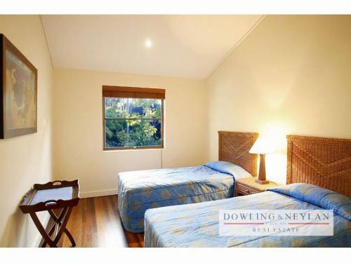 a hotel room with two beds and a window at Little Cove Townhouse 3 Pandanus Street 14 in Noosa Heads