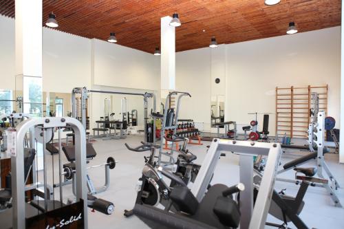 a gym with several treadmills and cardio machines at Arena Hotel Kur in Mingachevir