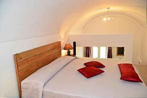 a bedroom with a bed with red pillows on it at B&B Torre Porta Marina in Ventimiglia