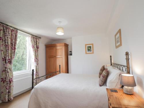 a bedroom with a bed and a window at 2 Riverside in Inverness
