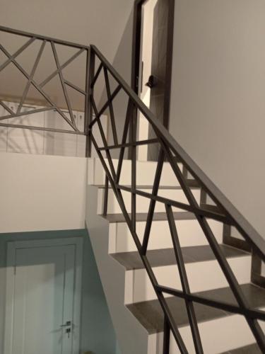 a spiral staircase in a white room with a door at 39 Apart Hotel in Lviv