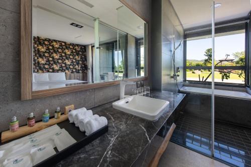 a bathroom with a sink and a mirror at Tan Villa in Taitung City