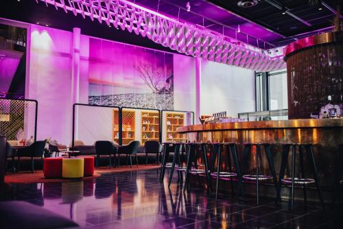 a bar with chairs and purple lighting in a room at Quality Hotel Globe in Stockholm