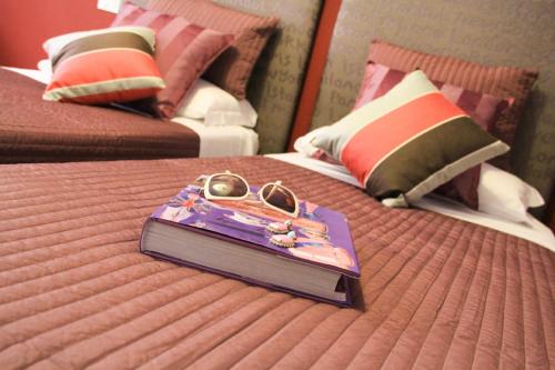 a purse on top of a bed in a room at Hotel Bologna in Genova