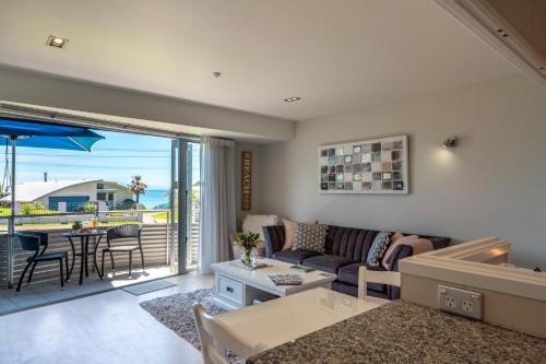 a living room with a couch and a table at Oneroa Bay Villas in Oneroa