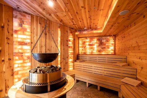 a sauna with a bucket hanging from the ceiling at Hotel Restaurant Waldsägmühle in Pfalzgrafenweiler