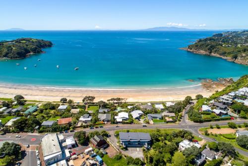 an aerial view of a beach with houses and the ocean at Oneroa Bay Villas in Oneroa