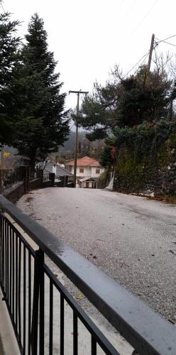 an empty street with a fence on the side of the road at Aetofolia Melissourgoi in Melissourgoi