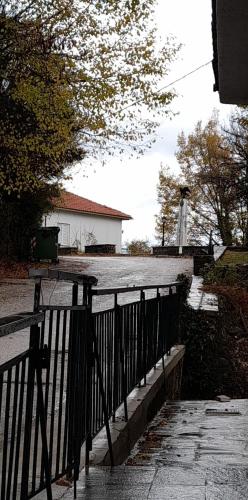 a black fence in front of a house at Aetofolia Melissourgoi in Melissourgoi